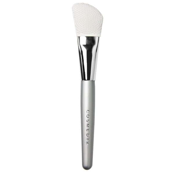 Cosmedix Dual-Sided Silicone Mask Applicator met geribbelde en gladde zijde voor een gelijkmatige aanbrenging van gezichtsmaskers.