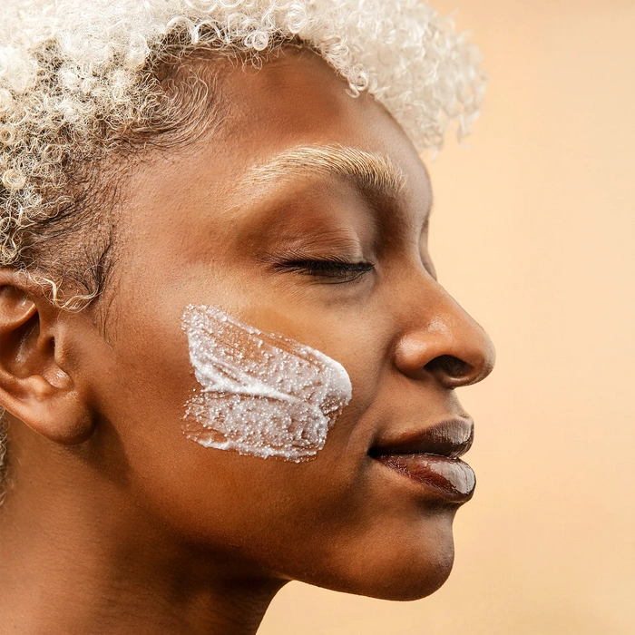 LYCON Skin Gentle Cleansing Scrub 75ml aangebracht op een gezicht, met focus op zacht exfoliërende textuur en glowy huid.