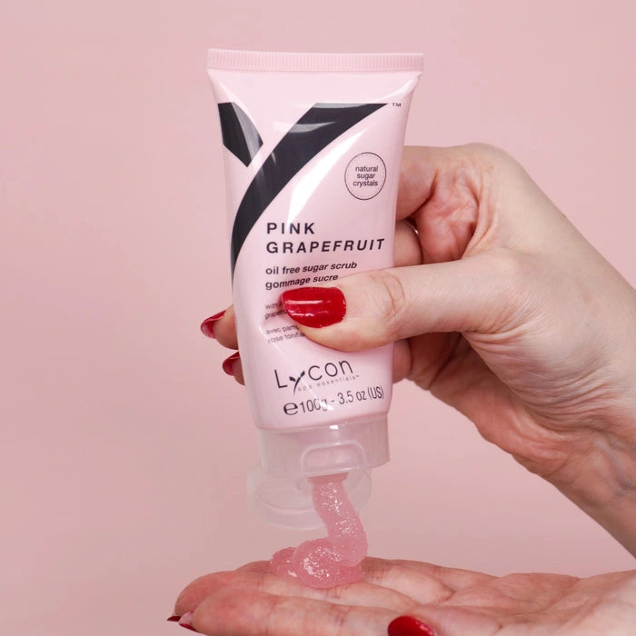Lycon Pink Grapefruit Sugar Scrub 100g in hand, showcasing the oil-free sugar scrub with pink texture, perfect for post-workout care.